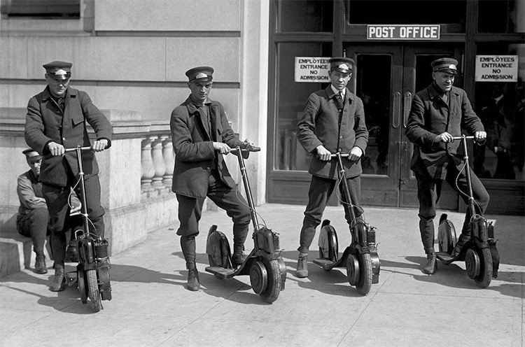 post office workers riding with autoped