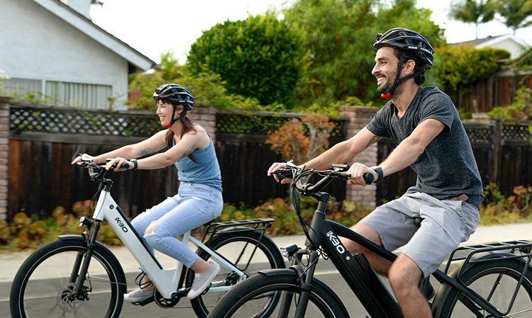 man and woman riding kbo electric bikes