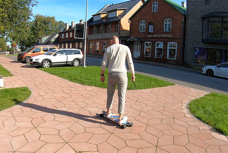 man enjoying riding with electric skateboard in urban environment