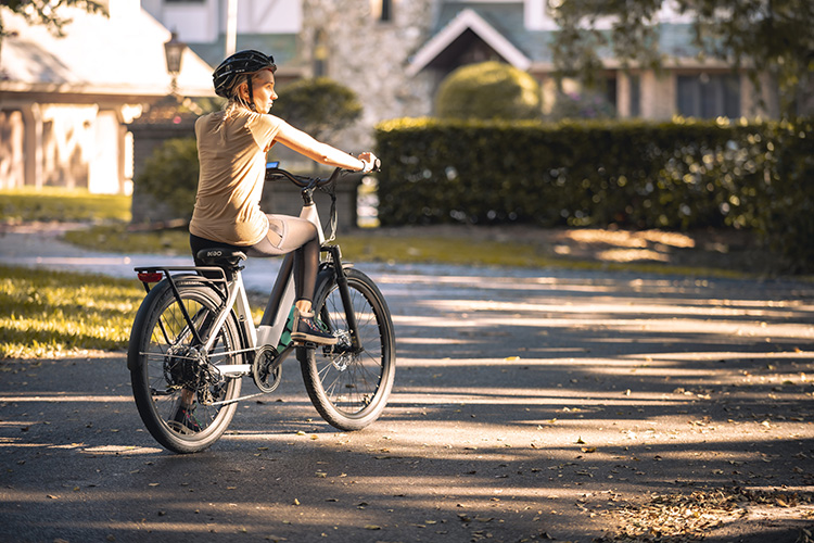 woman riding her kbo breeze commuter bike in an autumn