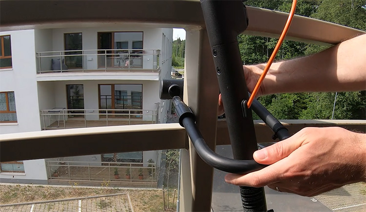 attaching a u-lock around the stem of an electric scooter