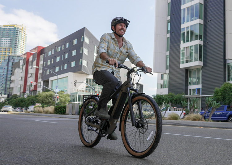 man riding a ride1up e-bike with a smile on his face