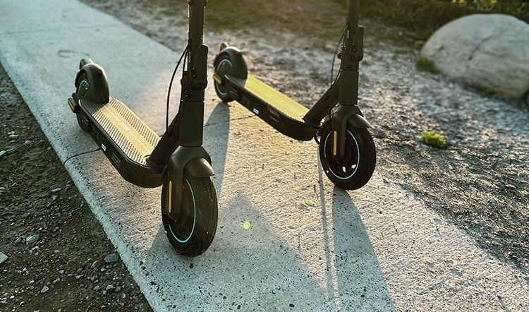 two ninebot max electric scooters on the small road.jpg