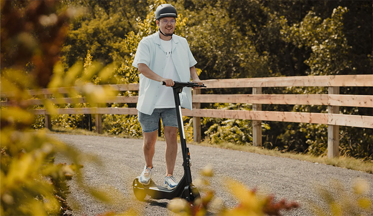 man is testing the apollo go electric scooter