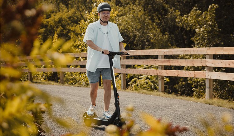 man is testing the apollo go electric scooter