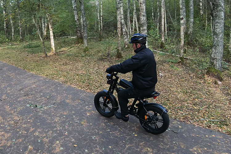 older man riding electric bike using a throttle only