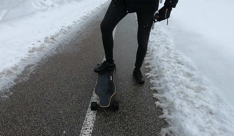 holding one foot on the skateboard