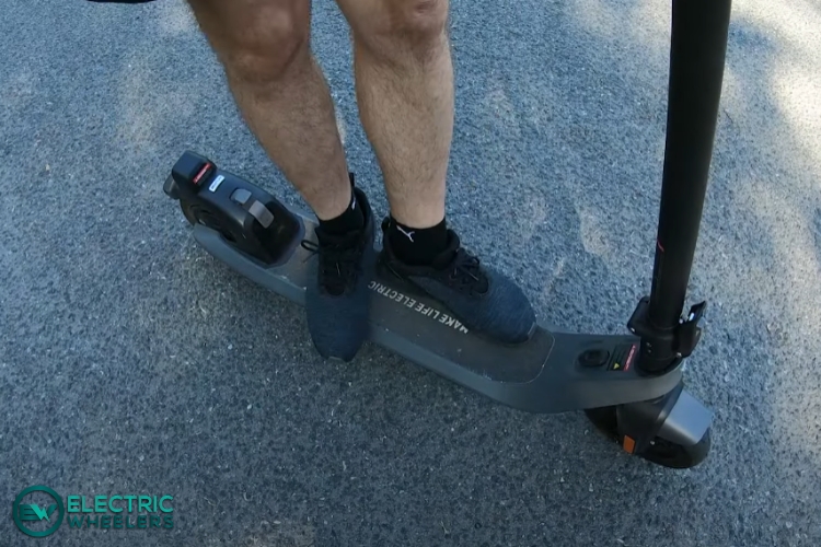 standing on electric scooter